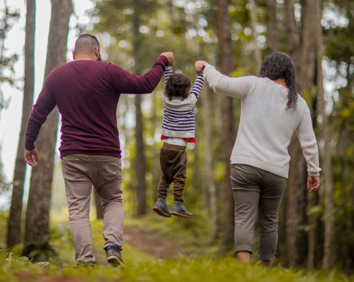 Man and Woman Carrying Toddler