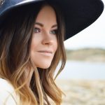 woman wearing black sun hat