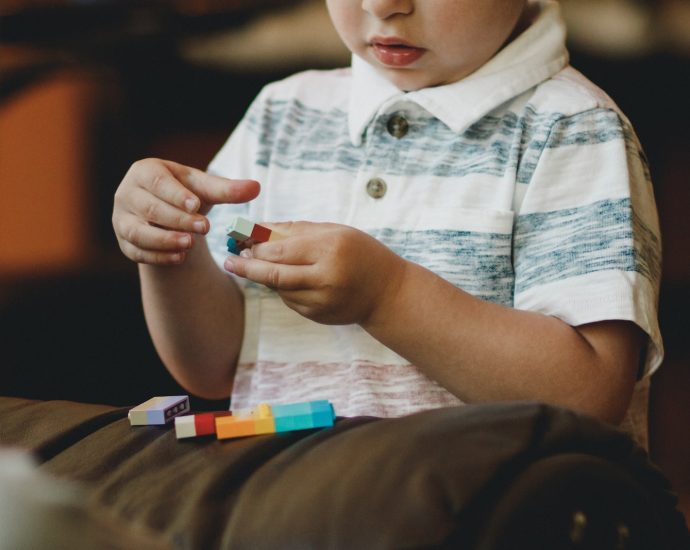 boy holding block toy