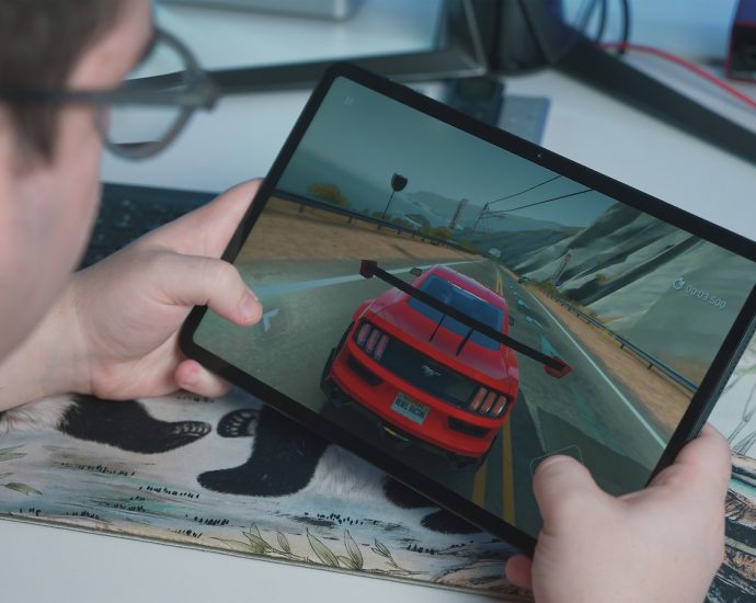 a man is playing a video game on his tablet