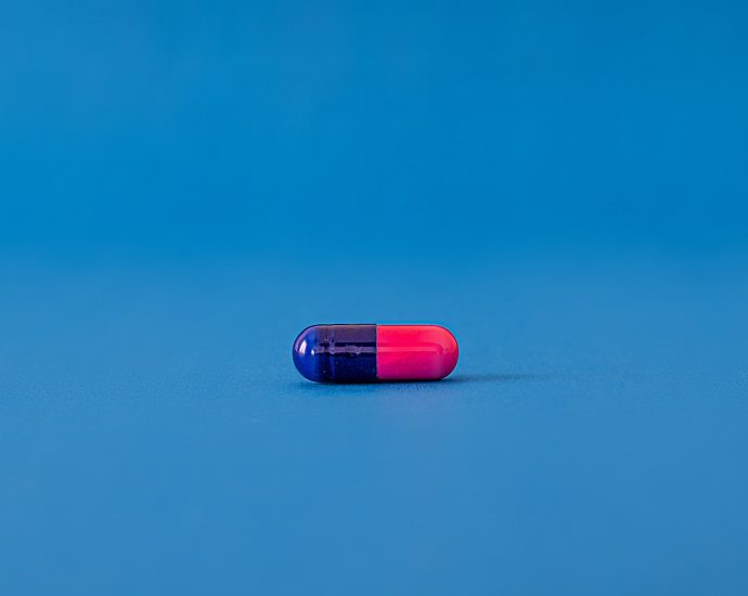 red and blue pill on blue surface