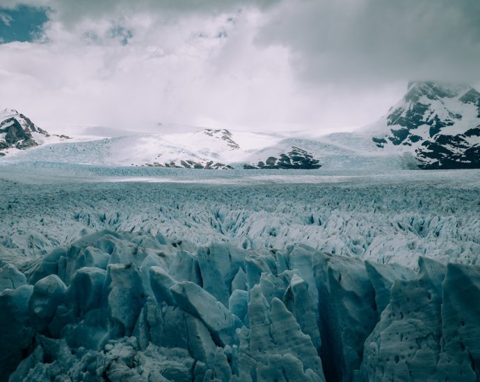 snow covered mountain under cloudy sky during daytime