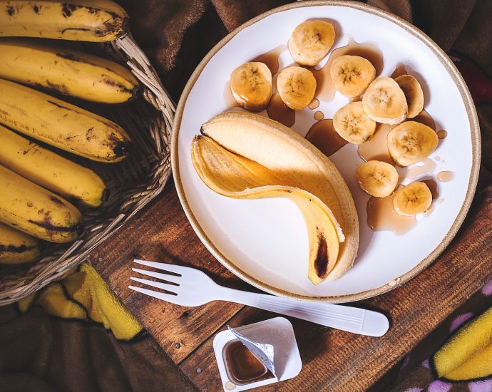 sliced ripe banana on round white ceramic plate