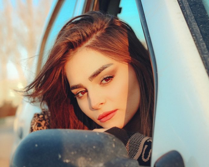 a woman leaning out of a car window