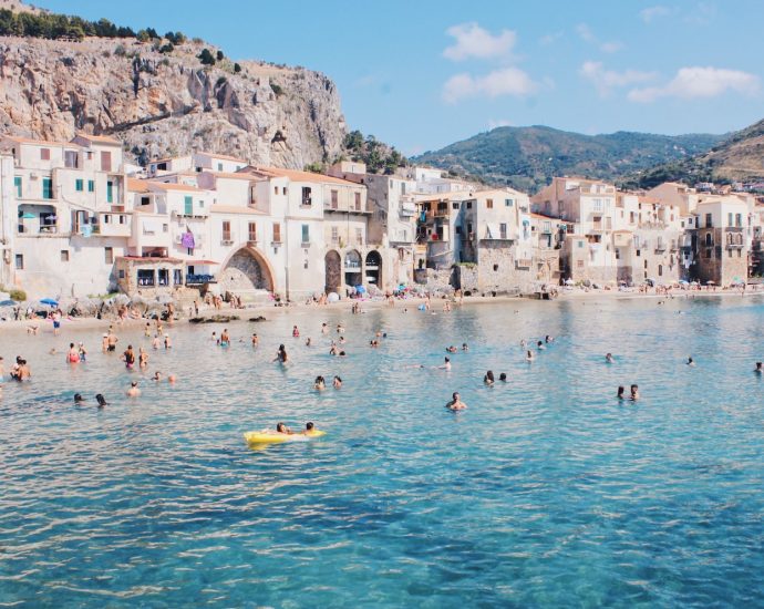 bunch of people swimming beach