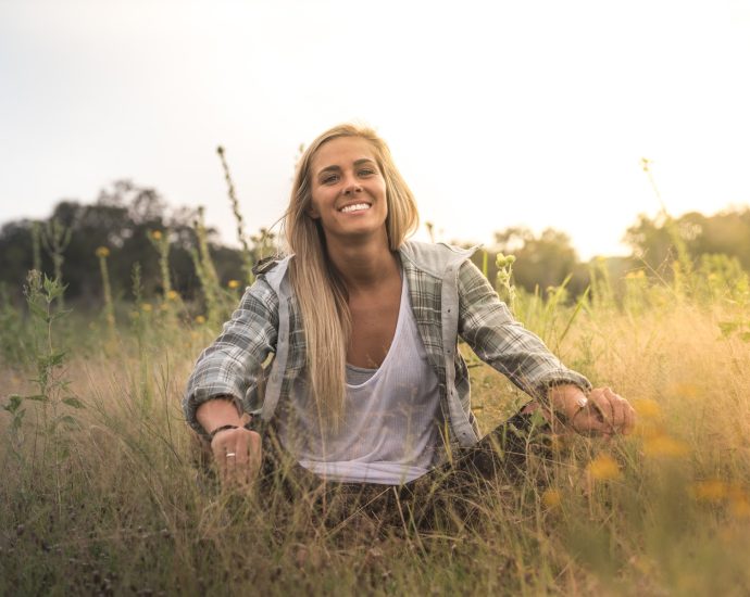 woman sitting on grass field