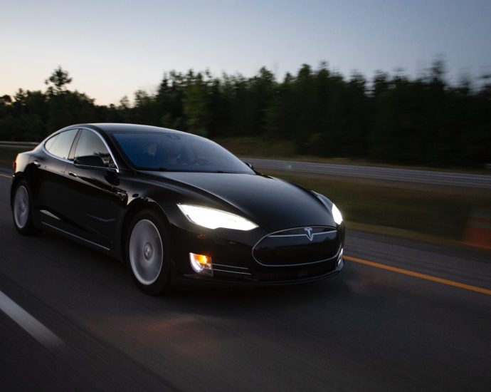 time-lapse photography of black sedan on road