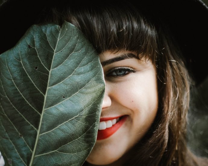 woman holding leaf