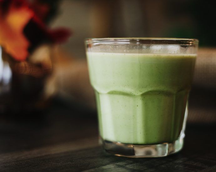 green liquid in clear drinking glass