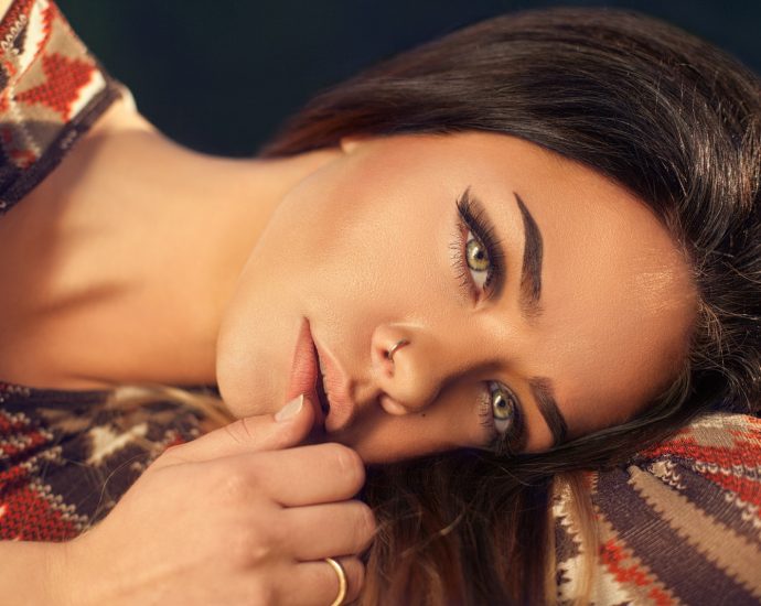 woman wearing red, white, and black aztec top