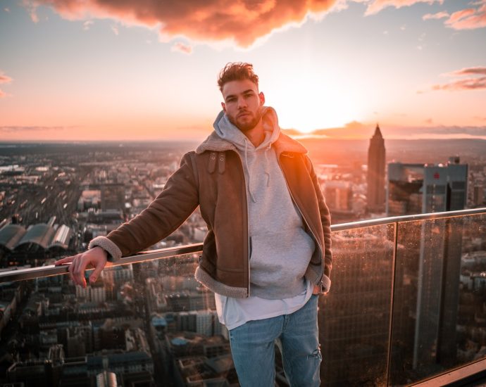 a man standing on top of a tall building