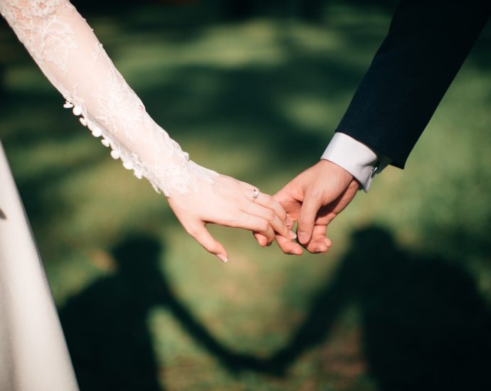 man and woman holding hands focus photo