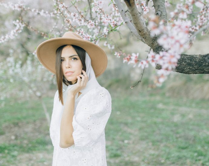 Beautiful Woman Wearing a White Dress and Brown Hat