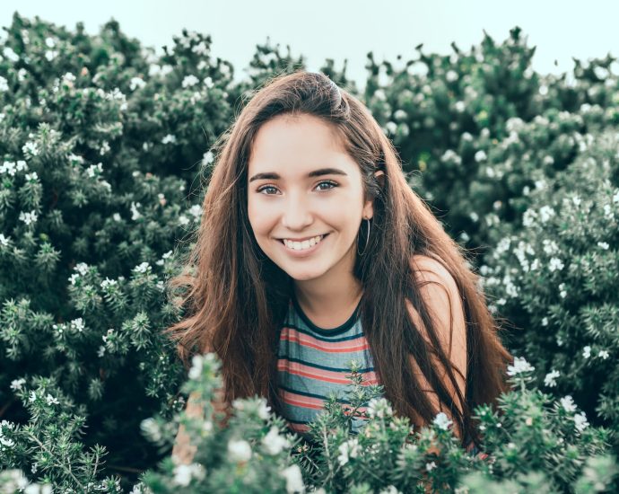 woman standing in bushes