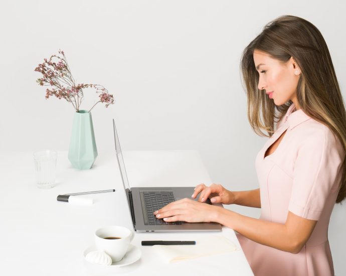 woman sitting while using laptop