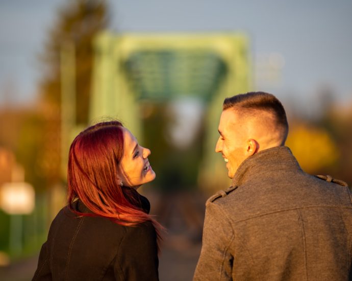 man and woman standing side by side during daytime