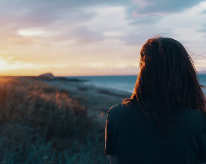 woman looking on body of water