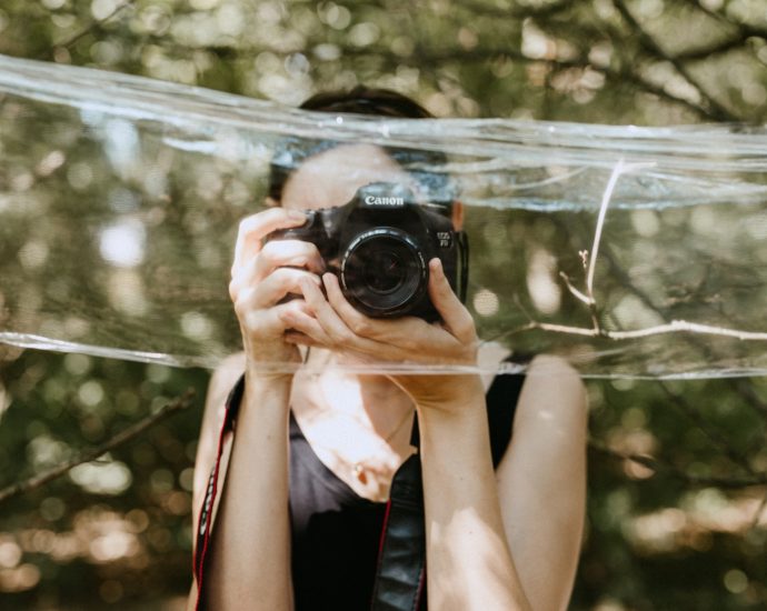 a woman taking a picture of herself in a mirror