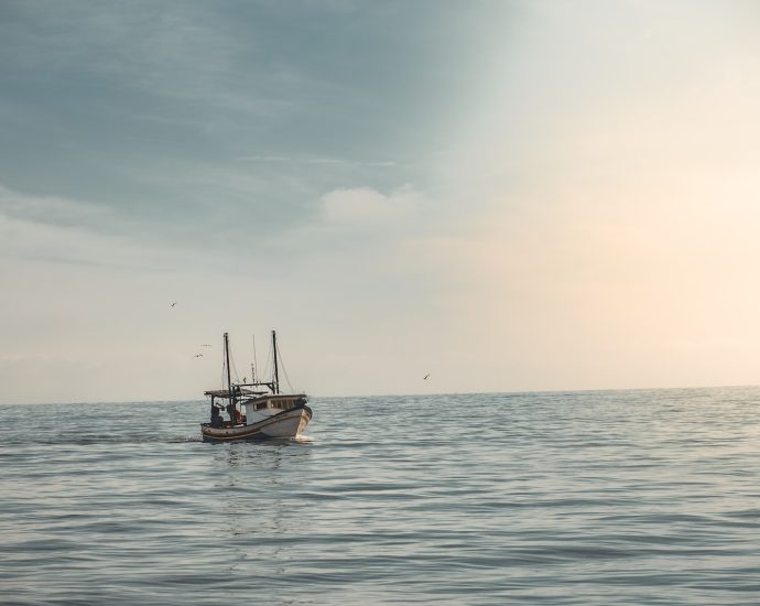 white boat sailing on ocean