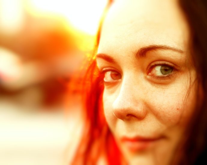 a close up of a woman with red hair