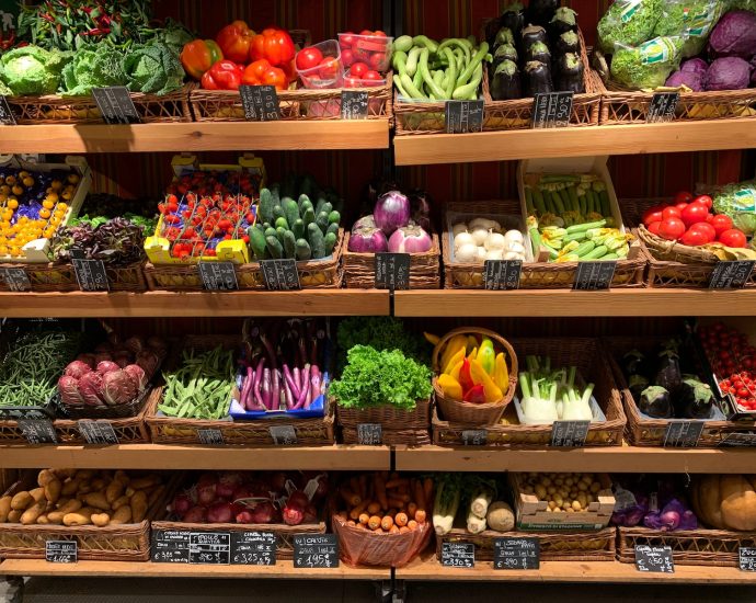 assorted fruits on brown wooden rack