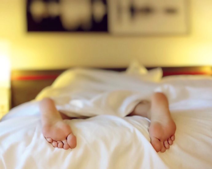 Person Lying on Bed Covering White Blanket