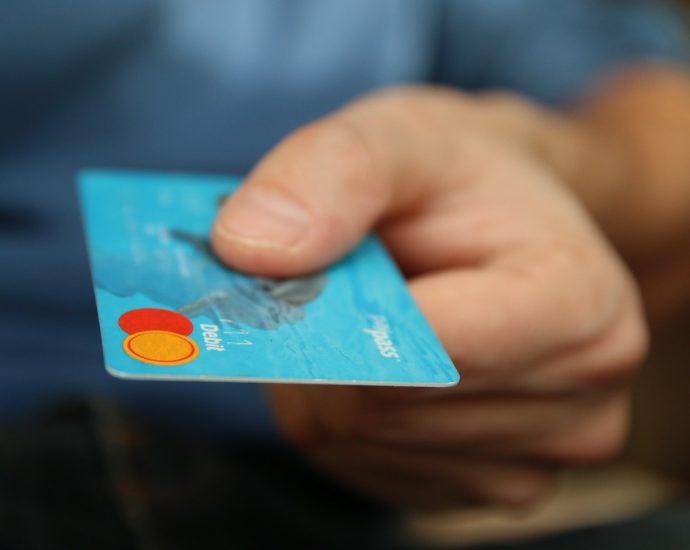 Person Holding Debit Card