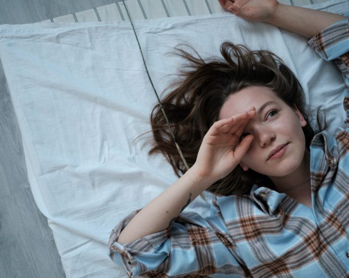 Top View of a Girl Wearing Checked Pyjama Lying Down on Matres