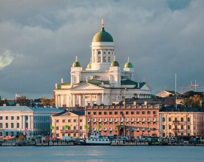 white concrete mosque near body of water