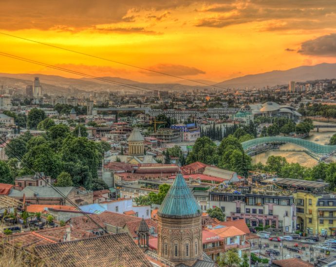 city with high-rise buildings under orange skies