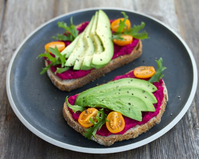 two sliced breads with avocado on top