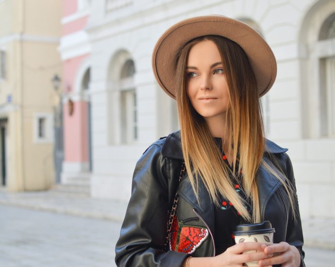 woman looking left side while holding plastic tumbler