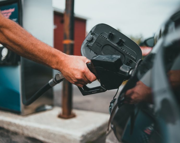 Person Putting Gasoline on a Vehicle