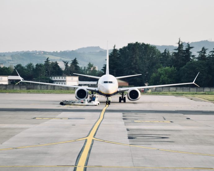 a large passenger jet sitting on top of an airport tarmac