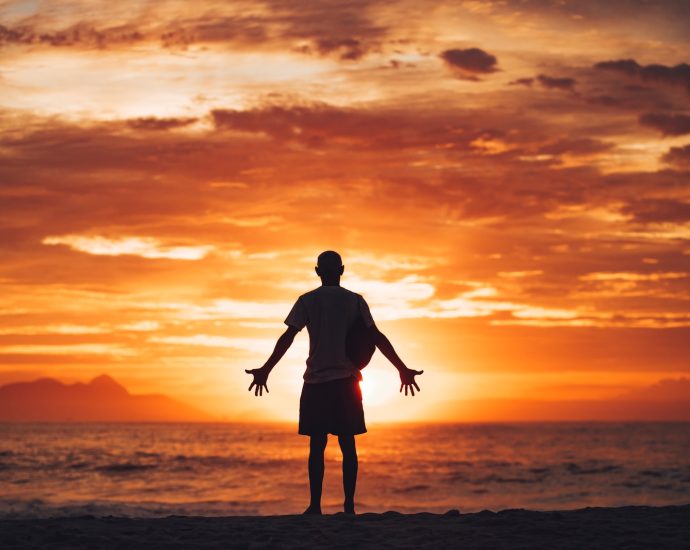 silhouette of man running on beach during sunset