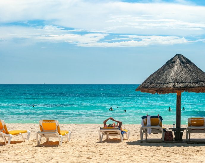 brown beach umbrellas on beach during daytime