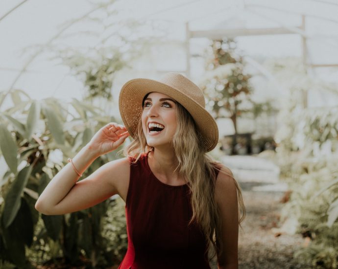 smiling woman wearing red sleeveless dress