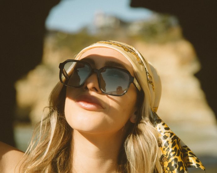 woman in brown and black leopard print shirt wearing black sunglasses