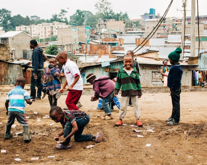 children playing on brown sand at daytime