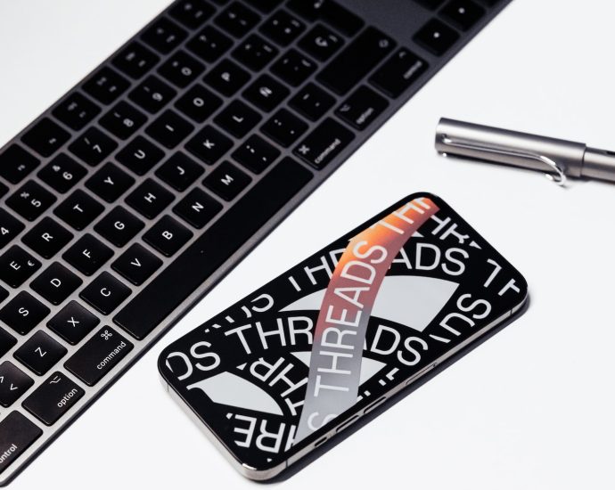 a keyboard and a pen sitting next to each other