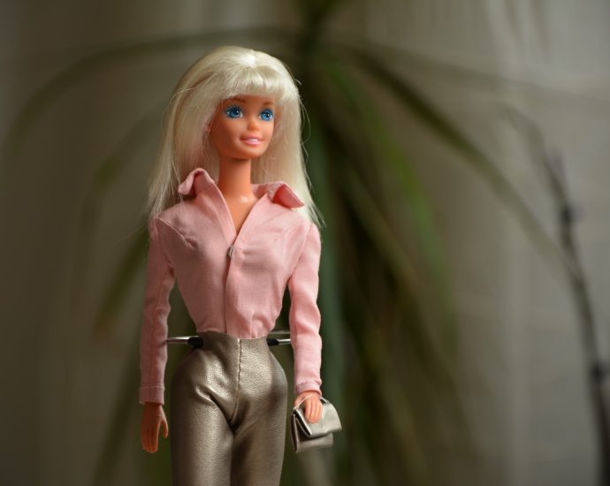 woman in pink dress shirt and gray pants