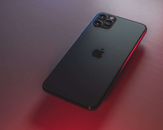 black iphone 7 plus on red table