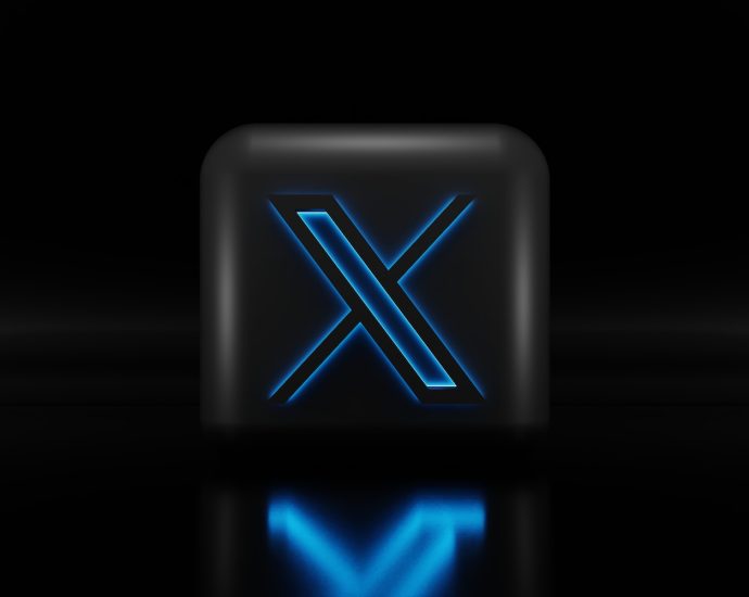 a blue illuminated letter x on a black background