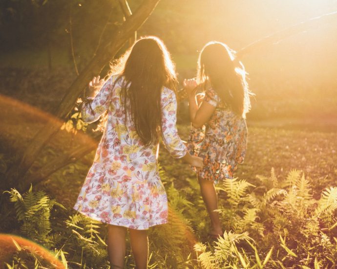 two women running around woods