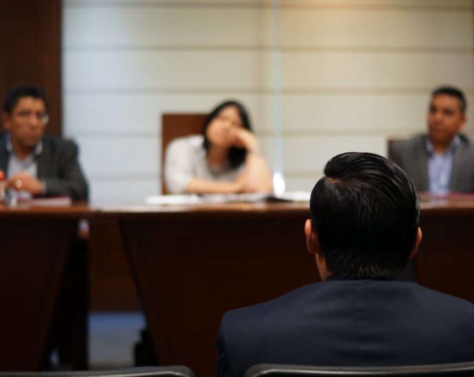 man in black shirt sitting beside woman in white shirt