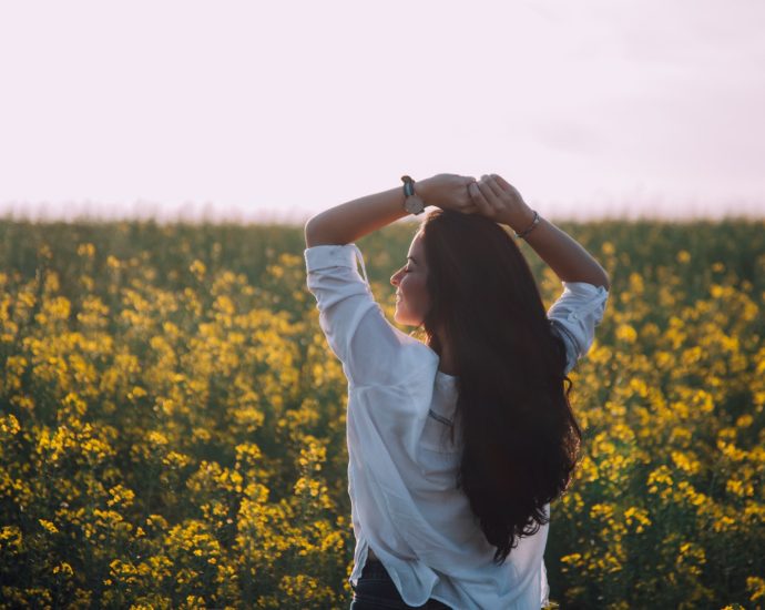 Woman Standing Near Yellow Flowers