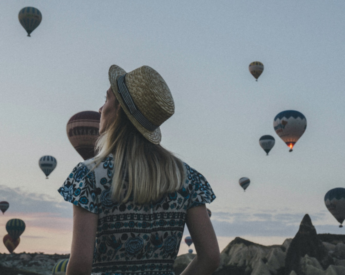 woman watching hot air balloons