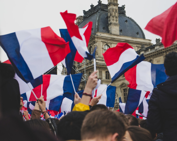 people holding France flag in the street