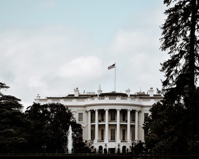 a white house with a flag on top of it