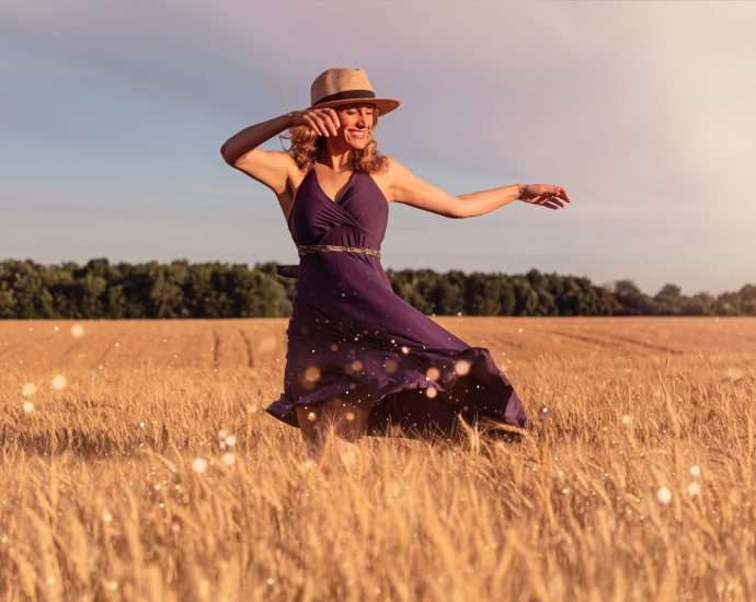 woman in brown sun hat standing on wheat field during daytime